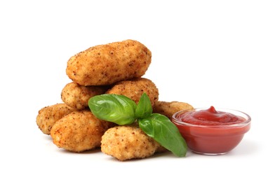 Photo of Tasty fried croquettes, basil and sauce isolated on white
