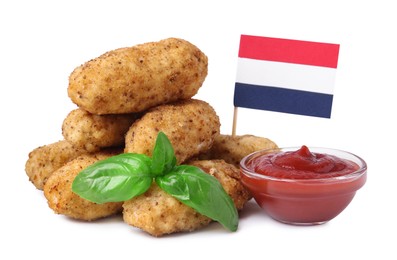 Photo of Tasty fried croquettes, basil, sauce and flag of Netherlands isolated on white