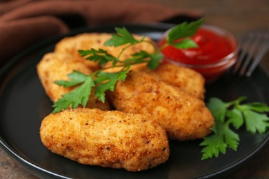 Photo of Tasty fried croquettes, parsley and sauce on wooden table, closeup
