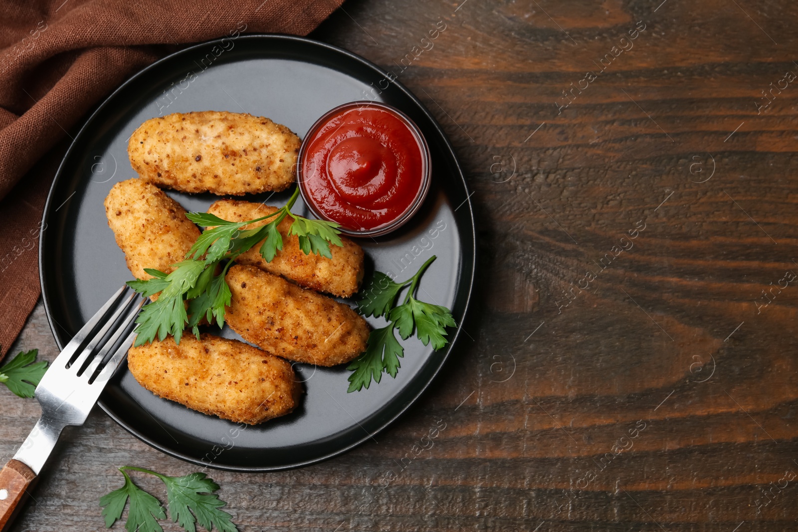 Tasty fried croquettes, parsley and sauce on wooden table, flat lay. Space for text Photo of Tasty fried croquettes, parsley and sauce on wooden table, flat lay. Space for text