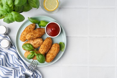 Photo of Tasty fried croquettes, basil and sauce served on white tiled table, flat lay. Space for text