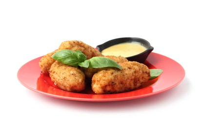 Photo of Tasty fried croquettes, basil and sauce isolated on white