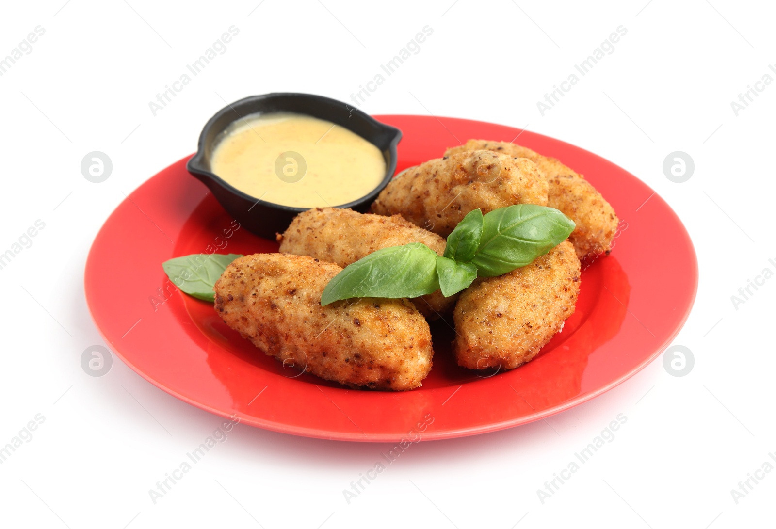 Tasty fried croquettes, basil and sauce isolated on white Photo of Tasty fried croquettes, basil and sauce isolated on white