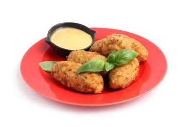 Photo of Tasty fried croquettes, basil and sauce isolated on white
