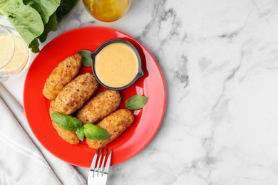 Photo of Tasty fried croquettes, basil and sauce served on white marble table, flat lay. Space for text
