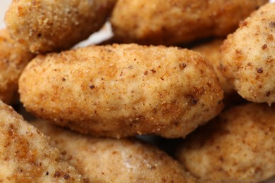 Photo of Tasty fried croquettes as background, closeup view