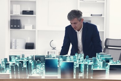 Illustration of Building information modelling. Man using holographic projection of city in office