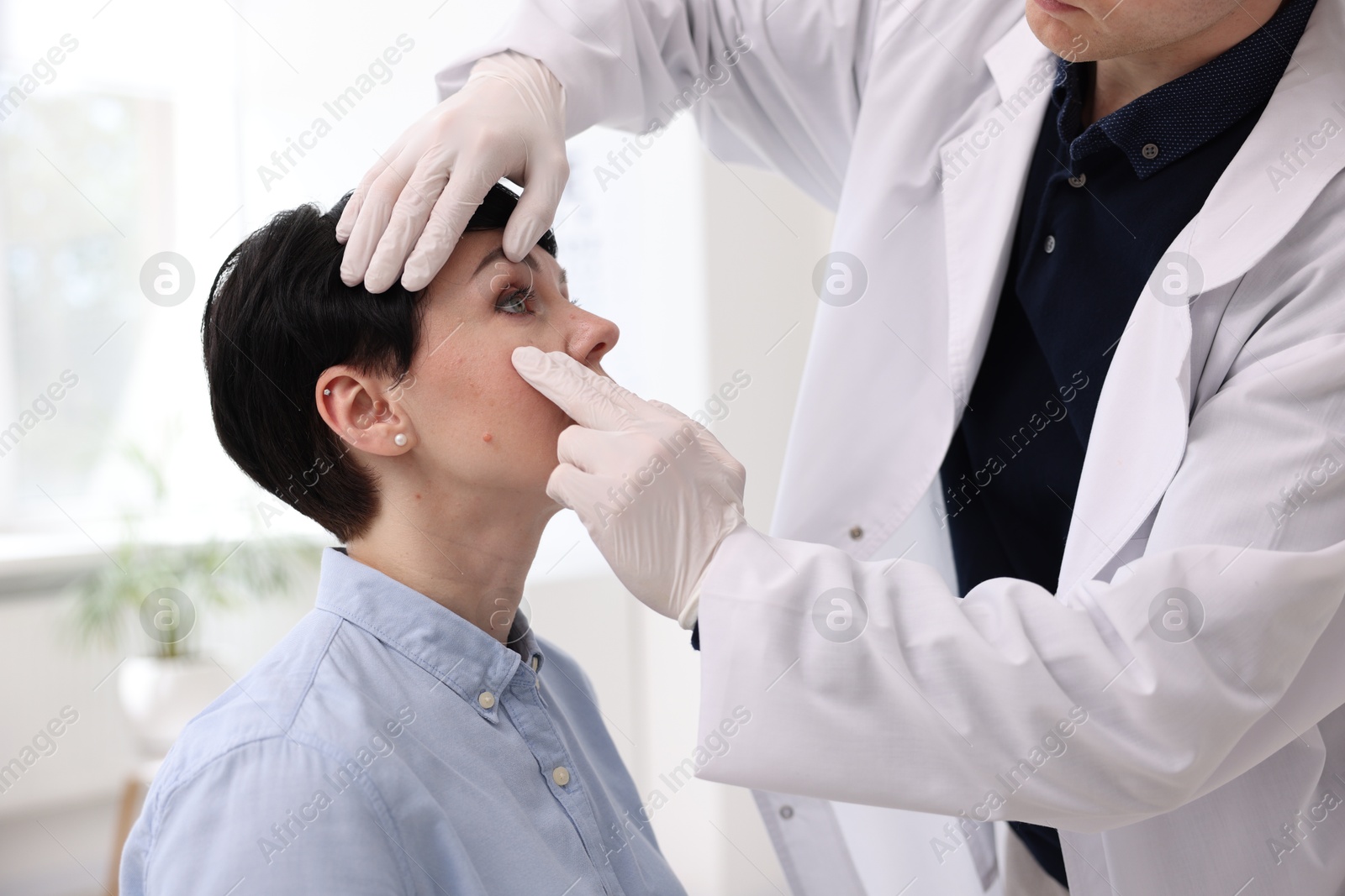 Professional ophthalmologist examining patient's vision in clinic, closeup Photo of Professional ophthalmologist examining patient's vision in clinic, closeup