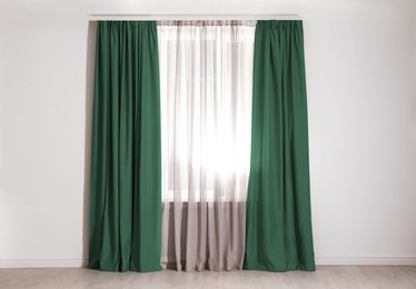 Image of Window with green curtains in room. Interior design