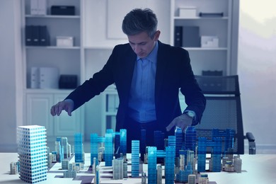 Illustration of Building information modelling. Man using holographic projection of city in office