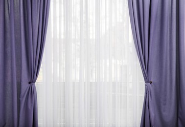 Image of Window with beautiful violet blue curtains. Interior design