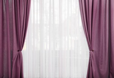 Image of Window with beautiful red purple curtains. Interior design