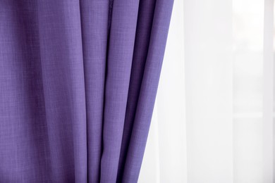 Image of Window with beautiful violet blue curtains. Interior design