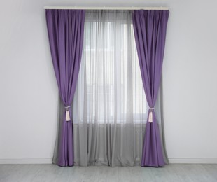 Image of Window with purple curtains in room. Interior design