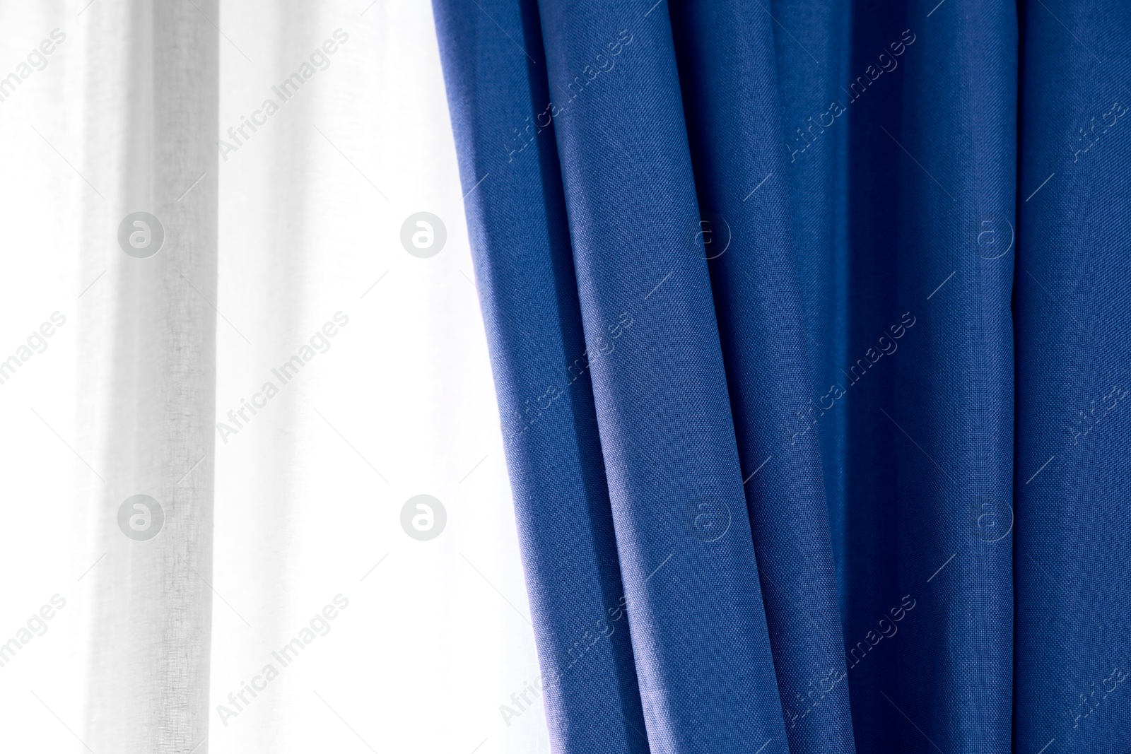 Window with beautiful blue curtains. Interior design Image of Window with beautiful blue curtains. Interior design