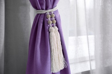 Image of Violet window curtains with tassel tieback, closeup view