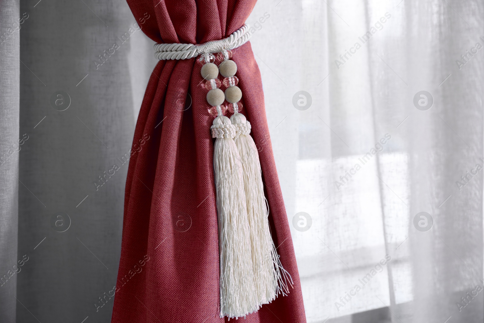 Red window curtains with tassel tieback, closeup view Image of Red window curtains with tassel tieback, closeup view