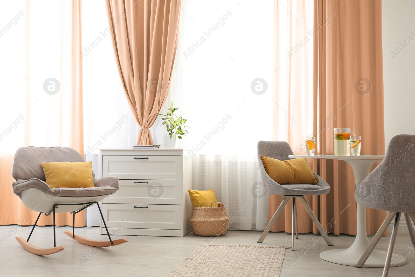 Different furniture and peach color curtains in room. Interior design Image of Different furniture and peach color curtains in room. Interior design