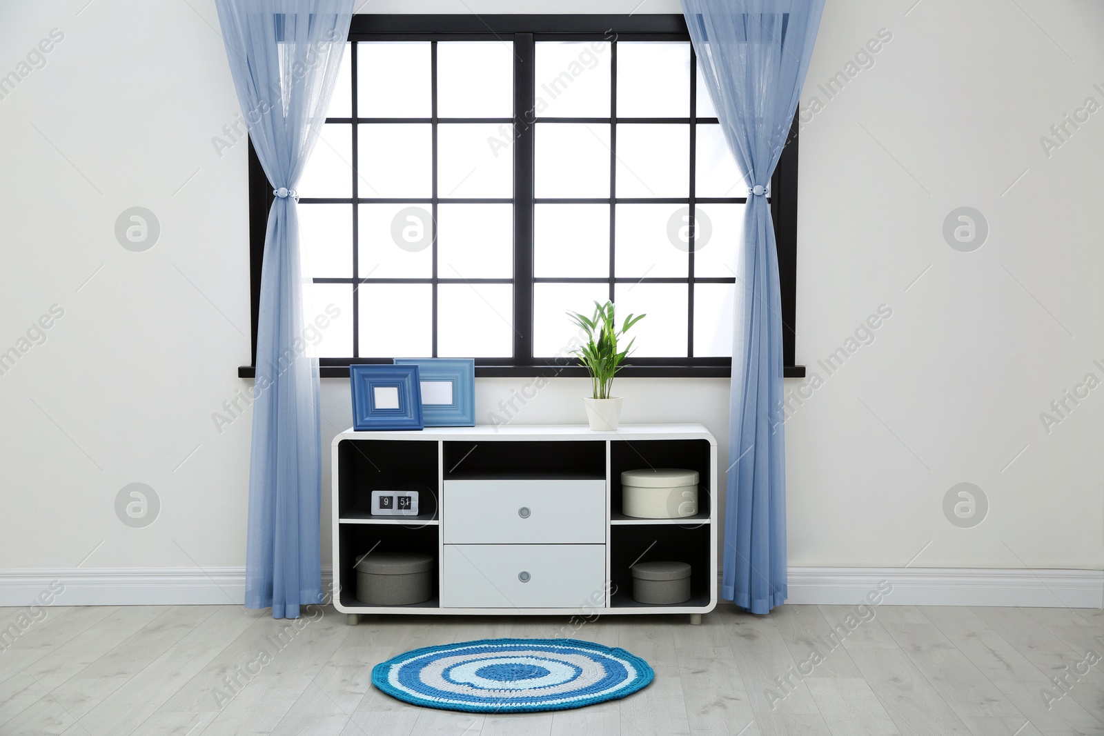 Window with pale blue curtains in room. Interior design Image of Window with pale blue curtains in room. Interior design