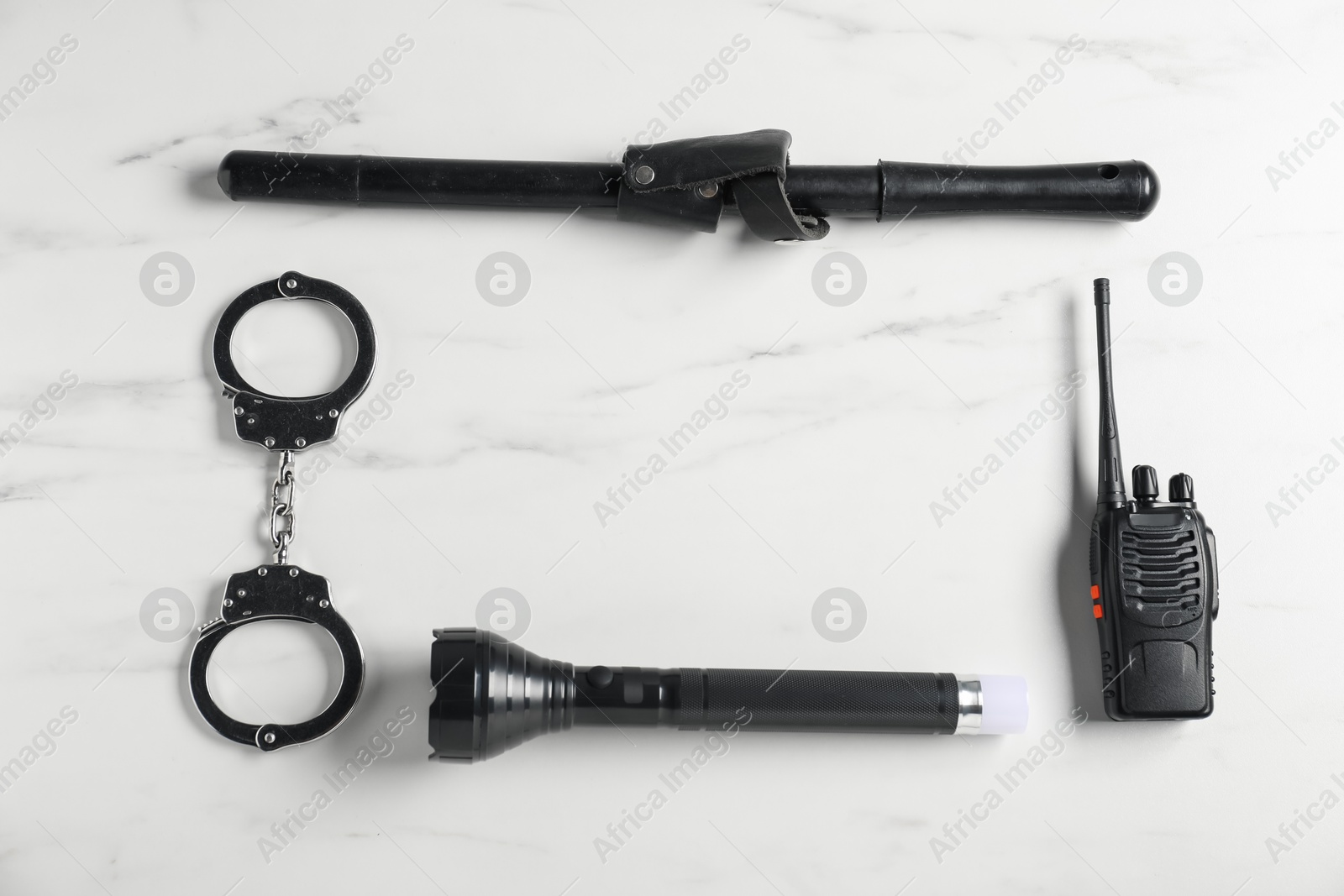 Different police equipment on white marble table, flat lay. Space for text Photo of Different police equipment on white marble table, flat lay. Space for text