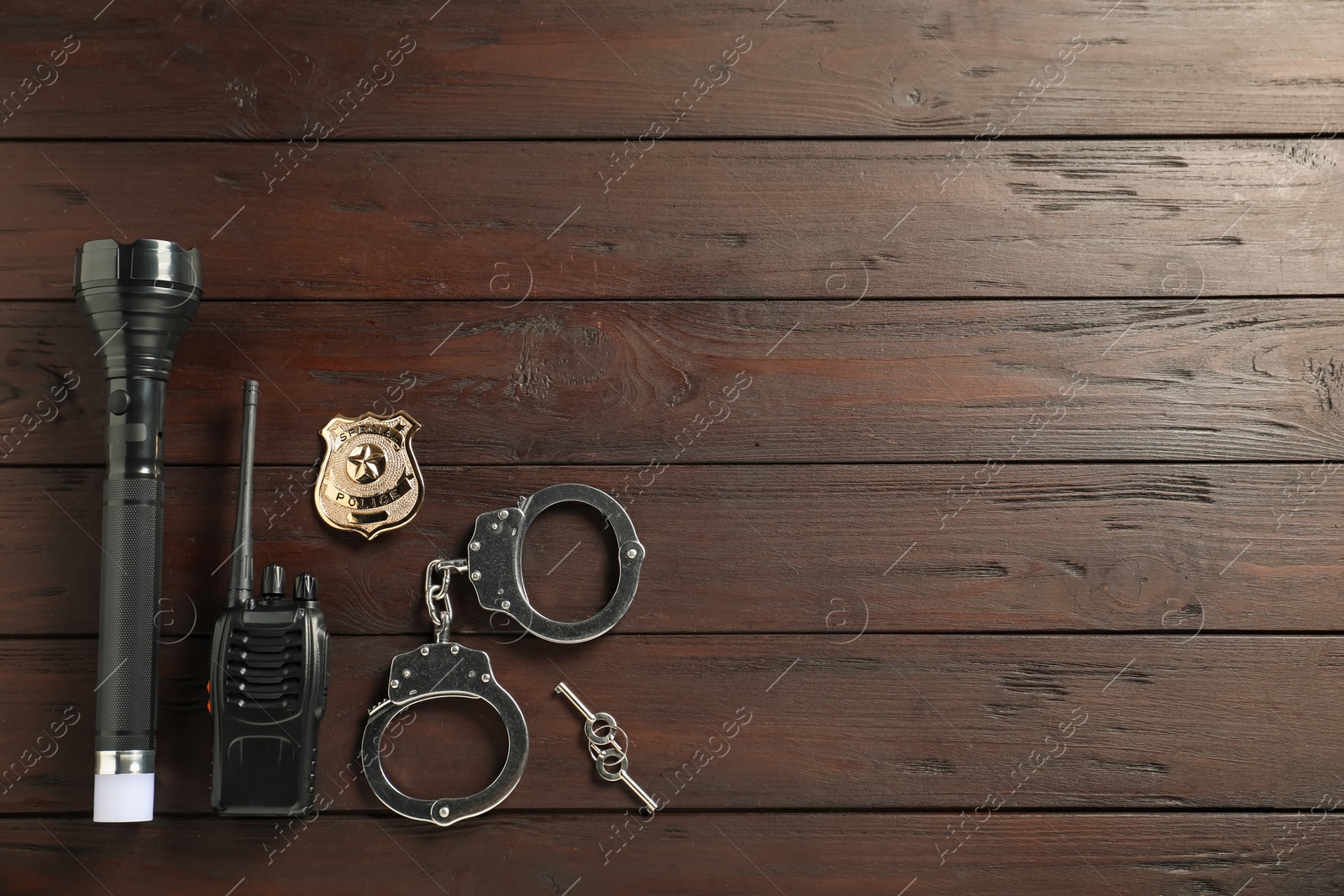 Different police equipment on wooden table, flat lay. Space for text Photo of Different police equipment on wooden table, flat lay. Space for text