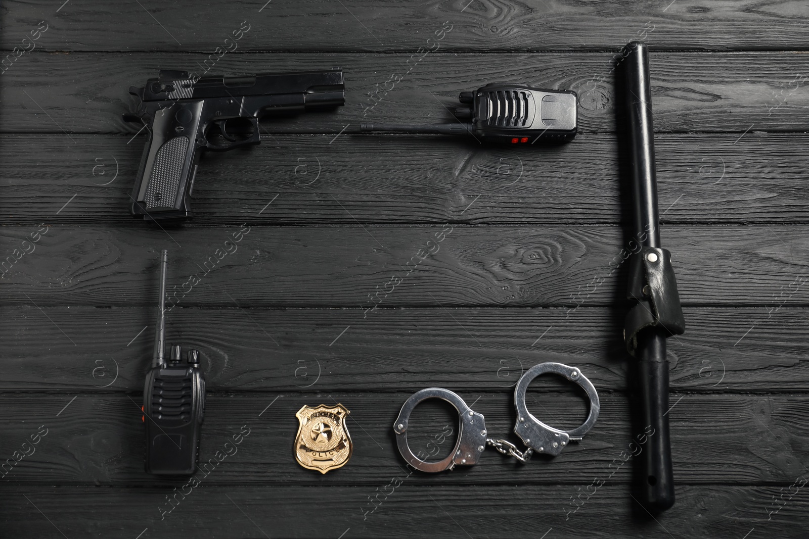 Different police equipment on black wooden table, flat lay. Space for text Photo of Different police equipment on black wooden table, flat lay. Space for text
