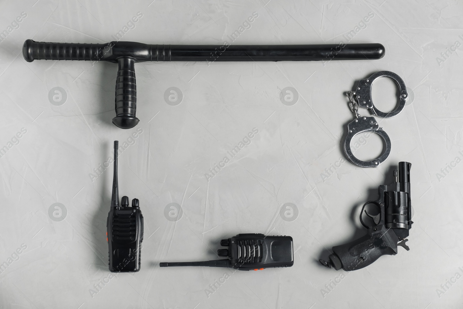 Different police equipment on light grey table, flat lay. Space for text Photo of Different police equipment on light grey table, flat lay. Space for text