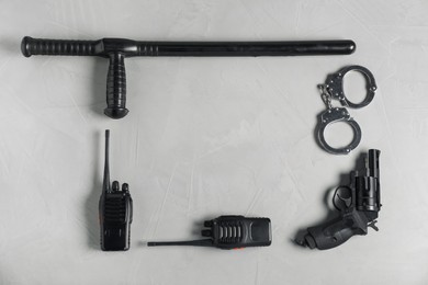 Photo of Different police equipment on light grey table, flat lay. Space for text