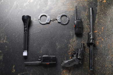 Photo of Different police equipment on dark table, flat lay. Space for text