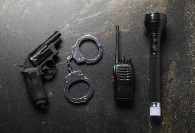 Photo of Different police equipment on dark table, flat lay