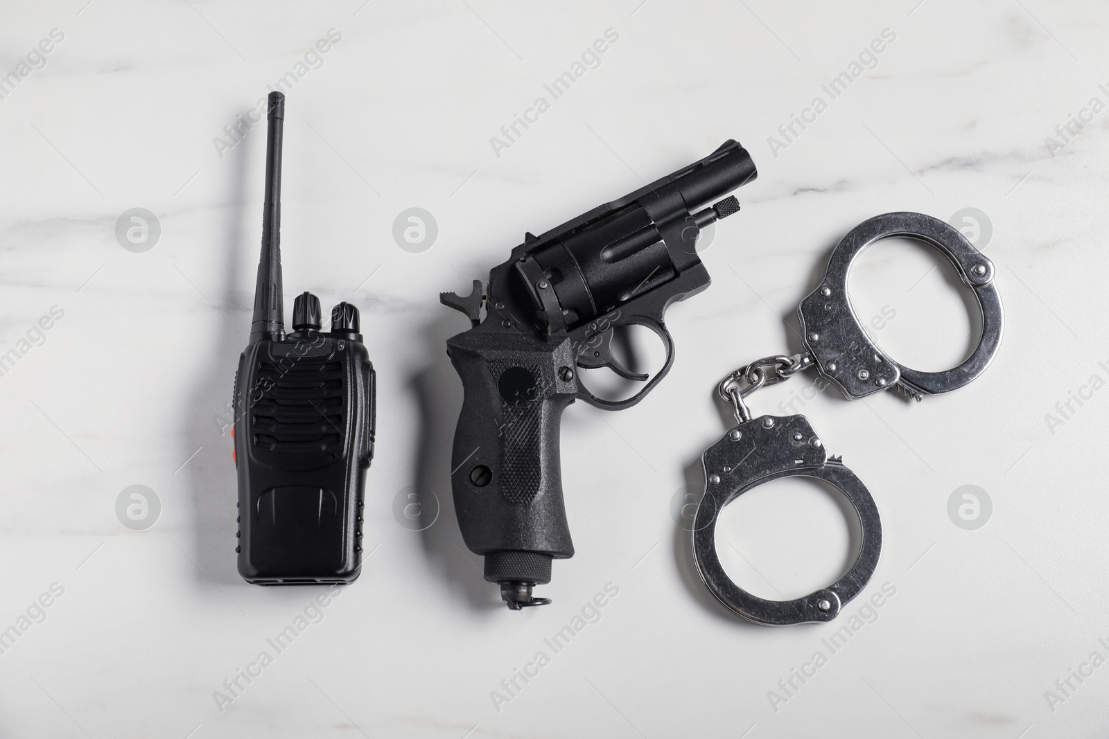 Photo of Different police equipment on white marble table, flat lay