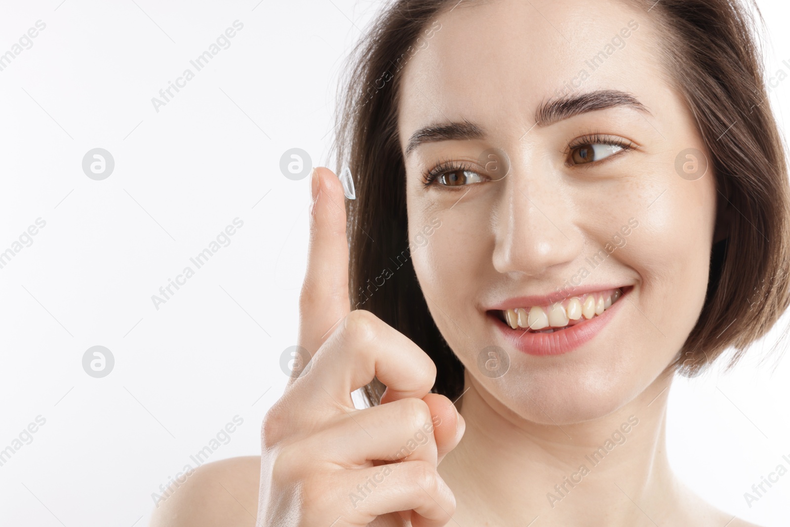 Woman with contact lens on white background, closeup Photo of Woman with contact lens on white background, closeup