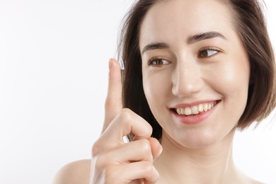 Photo of Woman with contact lens on white background, closeup