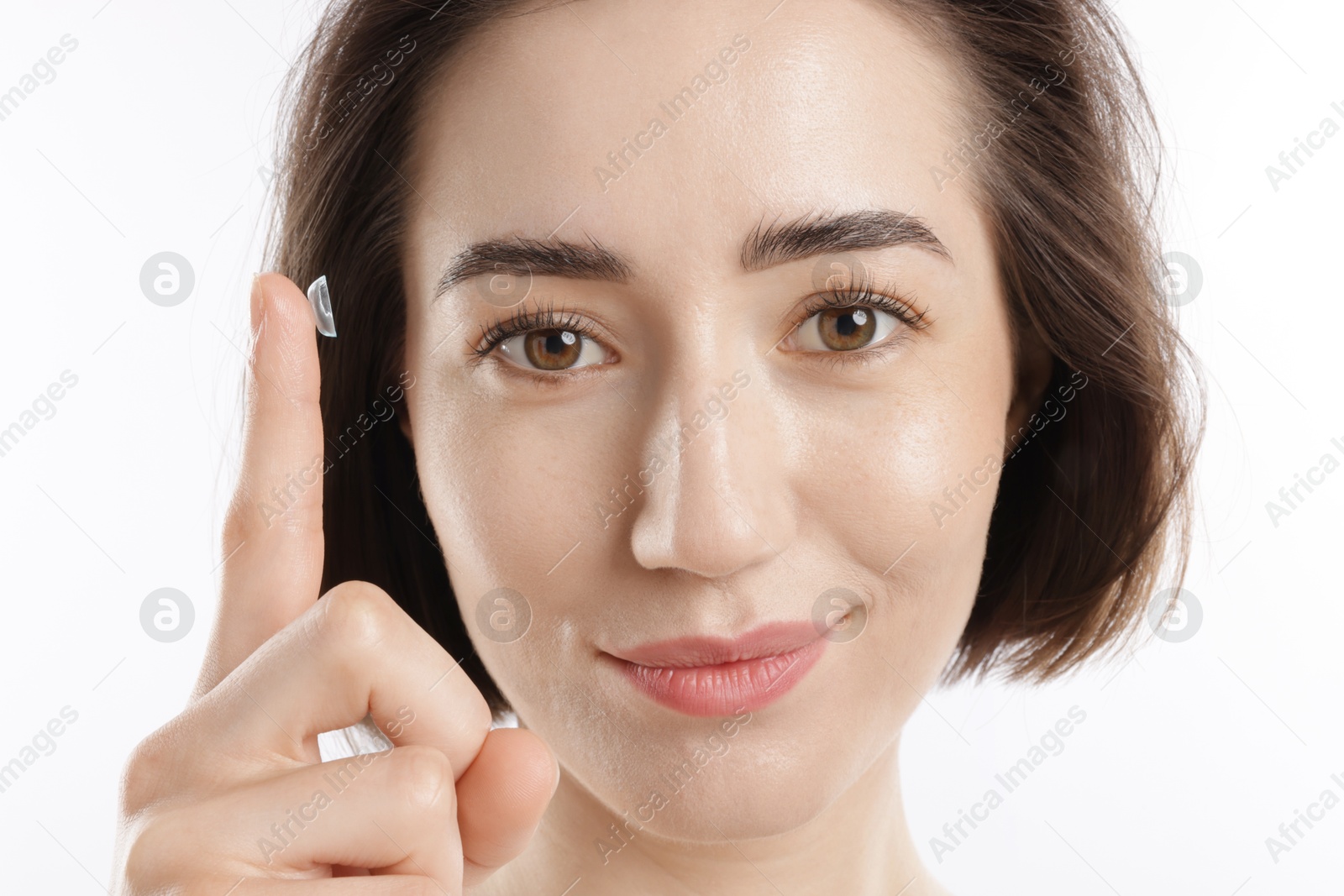 Woman with contact lens on white background, closeup Photo of Woman with contact lens on white background, closeup