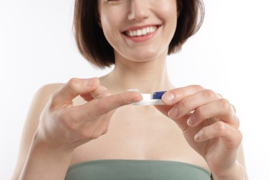 Photo of Woman with contact lens and case on white background, closeup