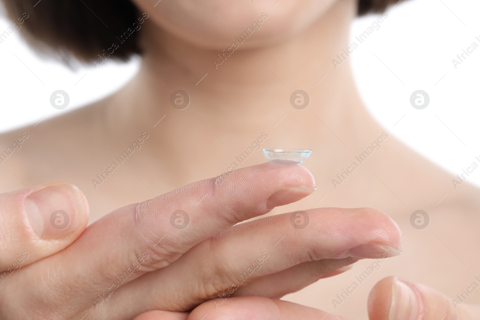 Woman with contact lens on white background, closeup Photo of Woman with contact lens on white background, closeup