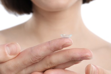 Photo of Woman with contact lens on white background, closeup