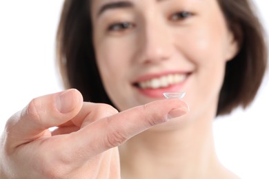 Photo of Woman with contact lens on white background, selective focus