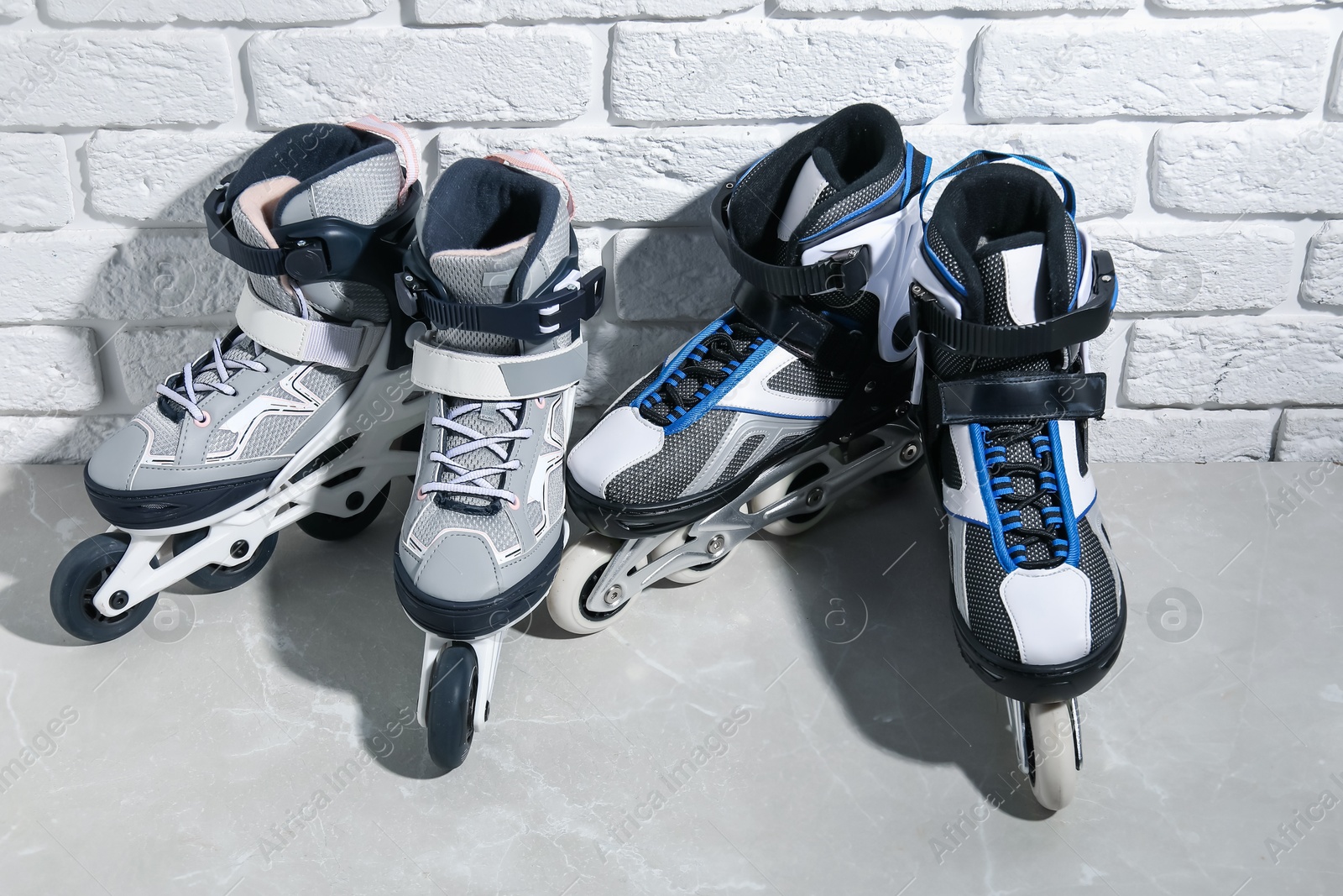 Roller skates on grey marble table near white brick wall, above view Photo of Roller skates on grey marble table near white brick wall, above view