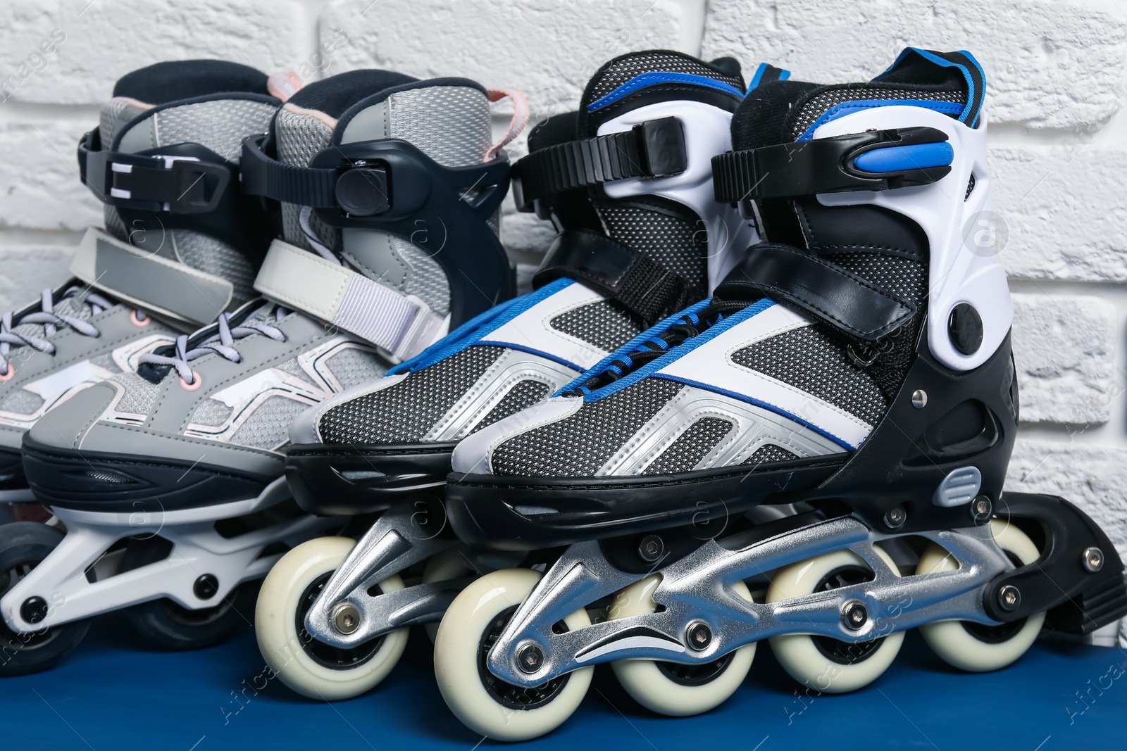 Roller skates on blue table near white brick wall, closeup Photo of Roller skates on blue table near white brick wall, closeup