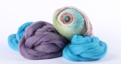 Photo of Felting wool and knitting yarn isolated on white