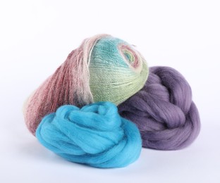 Photo of Felting wool and knitting yarn isolated on white