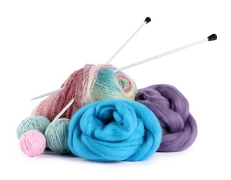 Photo of Felting wool and knitting yarn with needles isolated on white