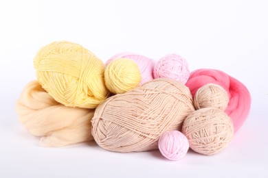 Photo of Felting wool and knitting yarn isolated on white