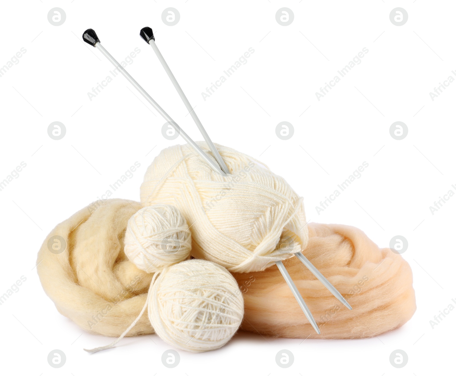 Felting wool and knitting yarn with needles isolated on white Photo of Felting wool and knitting yarn with needles isolated on white