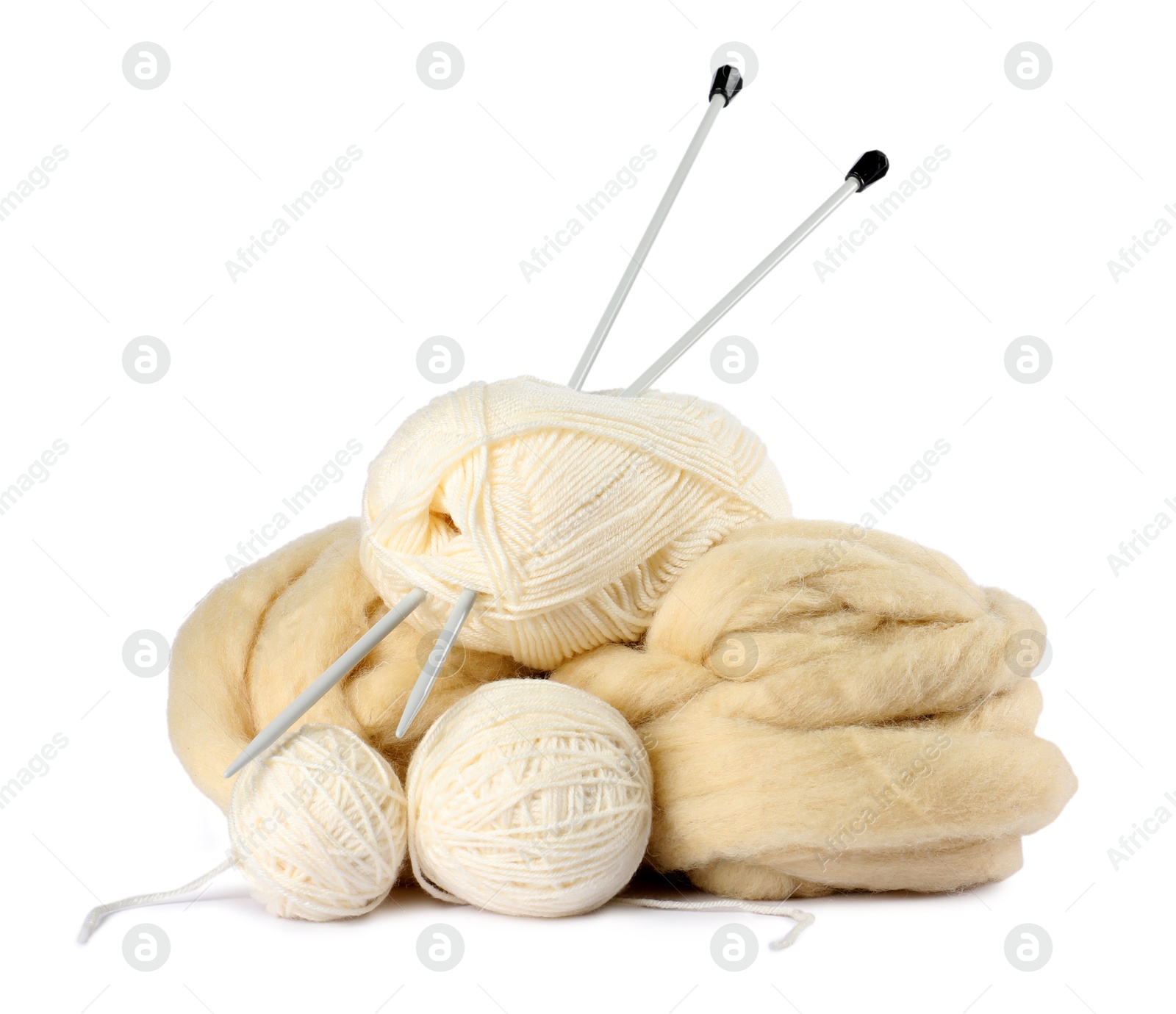 Felting wool and knitting yarn with needles isolated on white Photo of Felting wool and knitting yarn with needles isolated on white