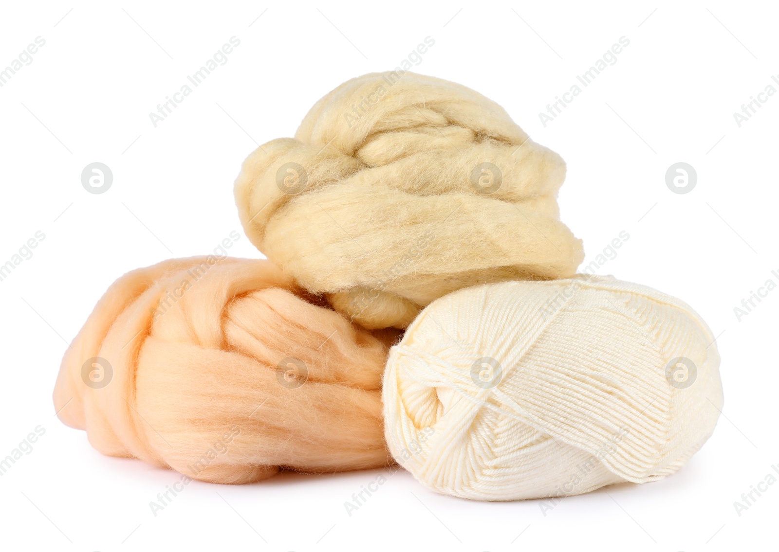 Felting wool and knitting yarn isolated on white Photo of Felting wool and knitting yarn isolated on white