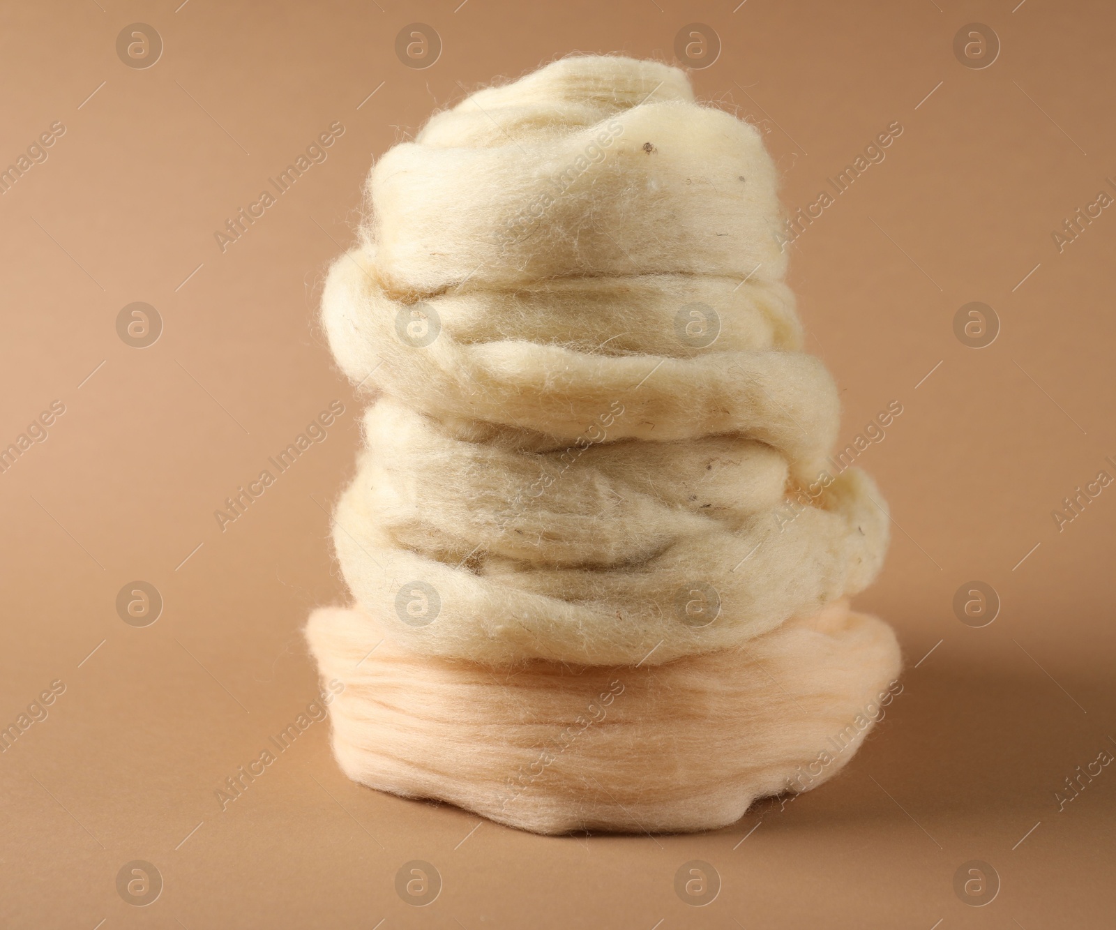 Natural felting wool on brown background, closeup Photo of Natural felting wool on brown background, closeup