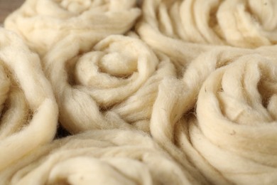Photo of Natural felting wool as background, closeup view