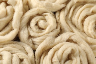 Photo of Natural felting wool as background, closeup view
